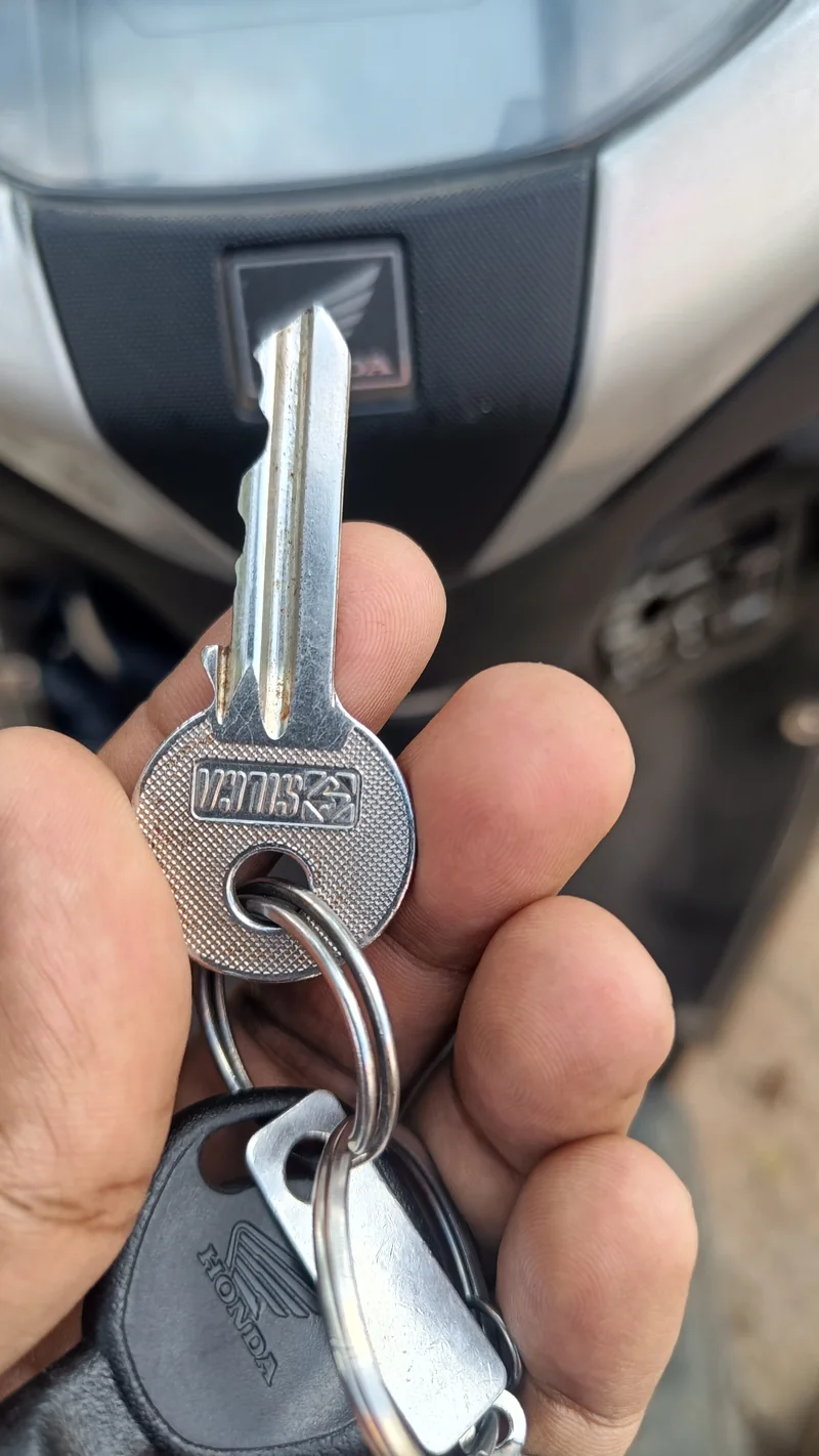 Bike key held in front of a scooter